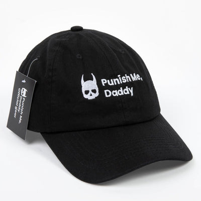 Slightly angled photo of black 100% cotton hat with official Punish Me, Daddy trademarked logo in the front